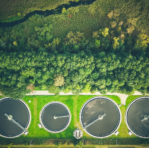 Aerial shot of sewage treatment plant placed near a river, Denmark. Aerial view shot with drone.