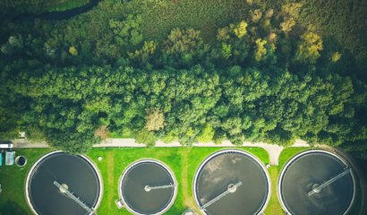 Aerial shot of sewage treatment plant placed near a river, Denmark. Aerial view shot with drone.